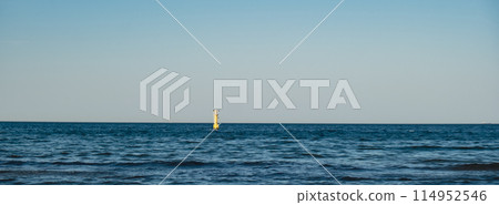 Yellow Lighthouse on blue sea line. Waves on sunny day on Baltic sea. Gdansk Poland.  114952546