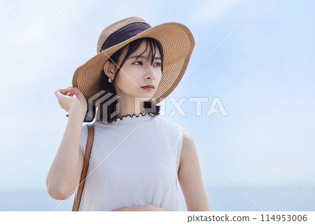 Young woman walking on the seaside 114953006