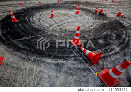 Race track road with tire mark skid road Backgroundn and traffic cone on road track, Motor sport asphalt race track and curbs with skid marks. Race track road with tire mark skid road Backgroundn and traffic cone on road track, Motor sport asphalt race track and curbs with skid marks. 114953211