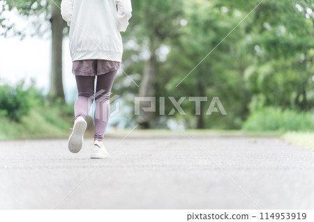 Feet of an Asian woman in sportswear walking and exercising in the park for dieting and calorie consumption Feet of an Asian woman in sportswear walking and exercising in the park for dieting and calorie consumption 114953919