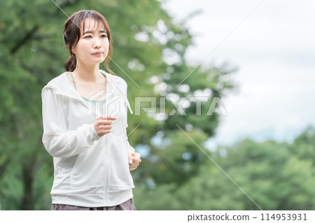 Asian woman in sportswear walking and exercising in the park for diet and calorie consumption Asian woman in sportswear walking and exercising in the park for diet and calorie consumption 114953931