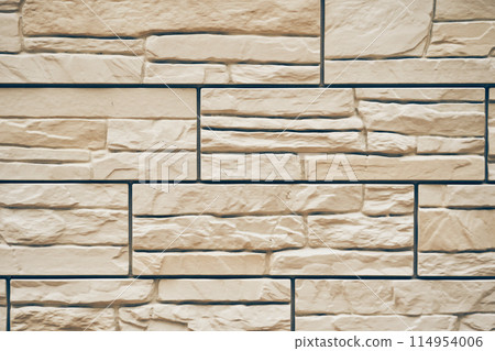 A stone texture with space to copy. Uneven tiles with protruding parts and cracks. High quality photo 114954006