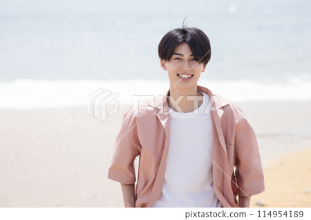 A young man playing on the beach A young man playing on the beach 114954189