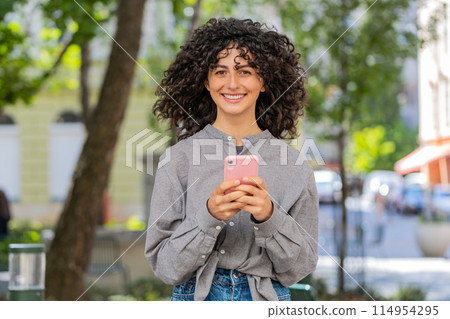 Caucasian young woman using smartphone typing text messages in social media application online Caucasian young woman using smartphone typing text messages in social media application online 114954295