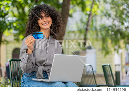 Caucasian young woman using credit bank card and laptop transferring money purchases online shopping Caucasian young woman using credit bank card and laptop transferring money purchases online shopping 114954296