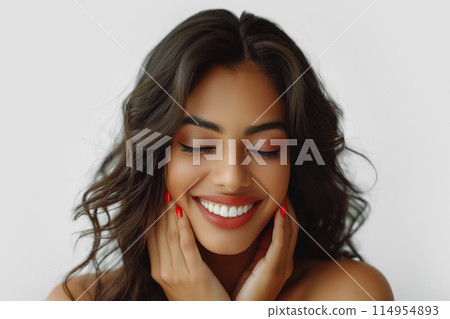 Indian young woman with dark hair, eyes closed, gently holding her face Indian young woman with dark hair, eyes closed, gently holding her face 114954893
