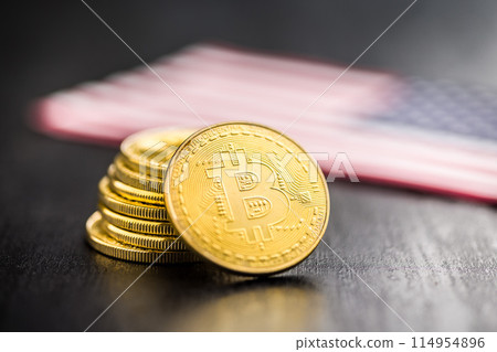 Bitcoin gold coin. Cryptocurrency with american flag on black table. 114954896