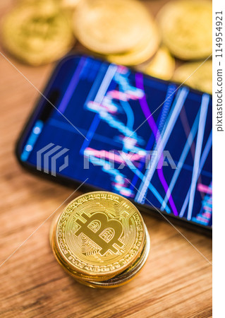 Bitcoin gold coin. Cryptocurrency and business chart in cellphone. 114954921