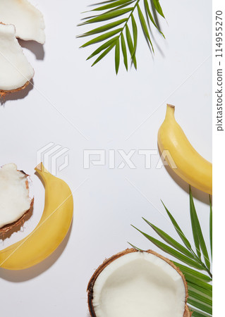 Minimalist product presentation scene with blank space in center, was shot from top view. Banana and coconut are common ingredients in various types of product such as cosmetic, culinary or beverage Minimalist product presentation scene with blank space in center, was shot from top view. Banana and coconut are common ingredients in various types of product such as cosmetic, culinary or beverage 114955270