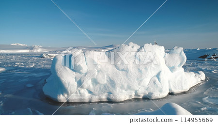 Ice floe stuck in frozen polar ocean in Antarctica. Arctic environment preserve ice. A breathtaking scene of Antarctic glacier. Natural beauty towering glacier. Ice float polar ocean. Aerial panorama Ice floe stuck in frozen polar ocean in Antarctica. Arctic environment preserve ice. A breathtaking scene of Antarctic glacier. Natural beauty towering glacier. Ice float polar ocean. Aerial panorama 114955669