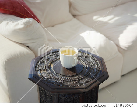 cup of tea on small table. 114956504