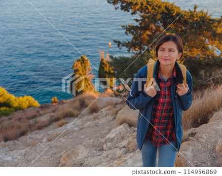 Young woman hiking on rocky beach in Spain, Benidorm Young woman hiking on rocky beach in Spain, Benidorm 114956869