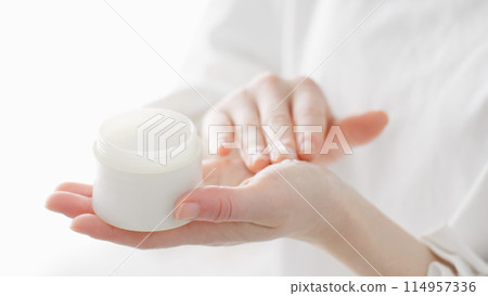 Woman applying skin care cream to her hands Woman applying skin care cream to her hands 114957336