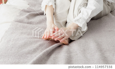 Woman rubbing cold feet 114957338