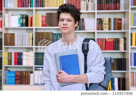 Portrait of college student teenage male inside library of educational building Portrait of college student teenage male inside library of educational building 114957890