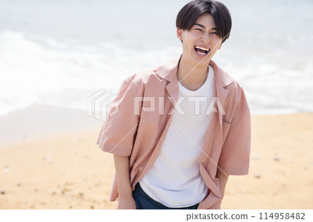 Cool man standing on the beach Cool man standing on the beach 114958482
