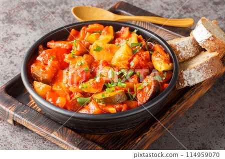 Homemade stew of zucchini, potatoes, peppers, onions, tomatoes and eggplant close-up in a bowl. Horizontal Homemade stew of zucchini, potatoes, peppers, onions, tomatoes and eggplant close-up in a bowl. Horizontal 114959070