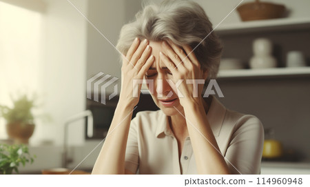 Tired mature woman with headache, stress, fatigue, temples pain, suffers from migraine at home 114960948