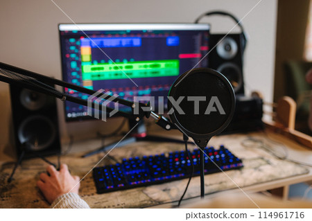 Workplace of musician at home. Table with pc and microphone. Open app for making melody 114961716