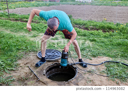 Pumping sewage from septic tank using submersible wastewater pump. Pumping sewage from septic tank using submersible wastewater pump. 114963082