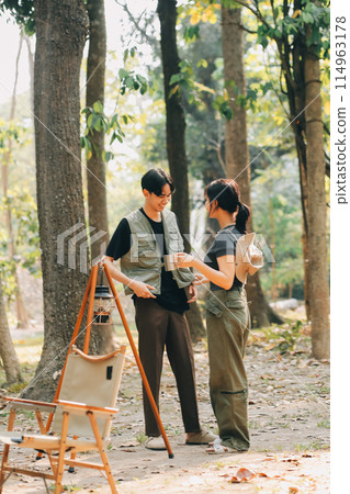 Asian couple sweet in tent inside on they camping trip, traveller relax and sleep togather in out door and camping trip Asian couple sweet in tent inside on they camping trip, traveller relax and sleep togather in out door and camping trip 114963178
