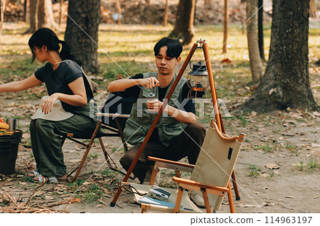 Asian couple sweet in tent inside on they camping trip, traveller relax and sleep togather in out door and camping trip Asian couple sweet in tent inside on they camping trip, traveller relax and sleep togather in out door and camping trip 114963197