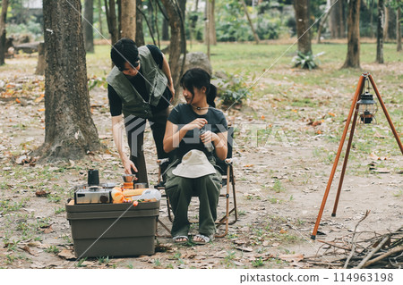 Asian couple sweet in tent inside on they camping trip, traveller relax and sleep togather in out door and camping trip Asian couple sweet in tent inside on they camping trip, traveller relax and sleep togather in out door and camping trip 114963198