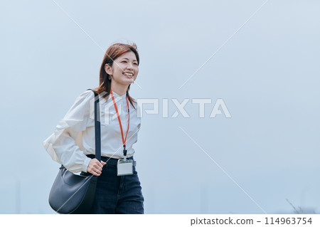 A young lady walking along the river 114963754