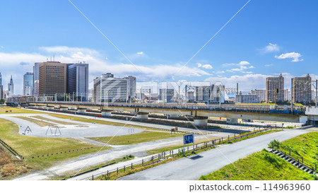 The Tama River riverbank and the buildings in front of Kawasaki Station [Kawasaki City, Kanagawa Prefecture - Ota Ward, Tokyo] 114963960