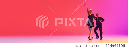 Banner. Talented ballroom dancers practicing dance moves in stages costumes in neon lighting against gradient background. 114964106