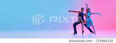 Banner. Young ballroom dancers practicing dance moves in stages costumes in neon lighting against gradient background. 114964185