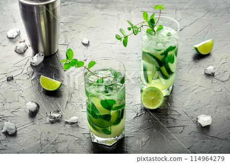 Mojito cocktail. Summer cold drink with lime, fresh mint, and ice. Cool beverage Mojito cocktail. Summer cold drink with lime, fresh mint, and ice. Cool beverage 114964279