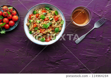 Quinoa tabbouleh salad in a bowl, a healthy dinner with tomatoes and mint Quinoa tabbouleh salad in a bowl, a healthy dinner with tomatoes and mint 114964284