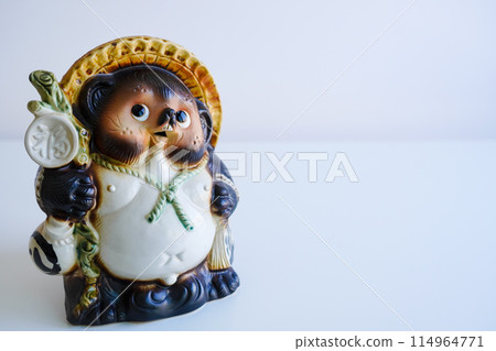 Cute Shigaraki ware raccoon on white background Copy space 114964771