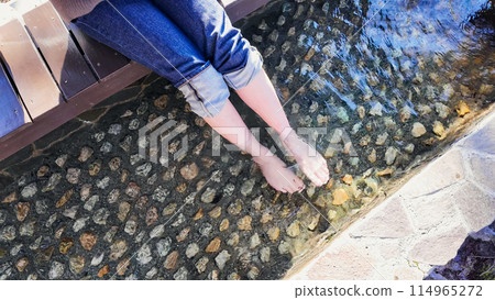 A woman entering a foot bath A woman entering a foot bath 114965272
