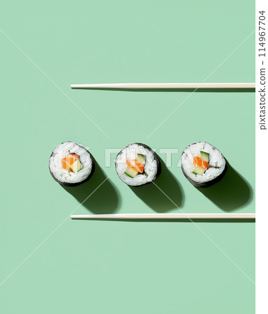 Set of sushi rolls top view over soft green background 114967704