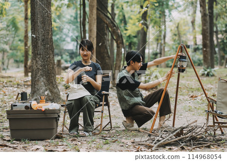 Asian couple sweet in tent inside on they camping trip, traveller relax and sleep togather in out door and camping trip Asian couple sweet in tent inside on they camping trip, traveller relax and sleep togather in out door and camping trip 114968054