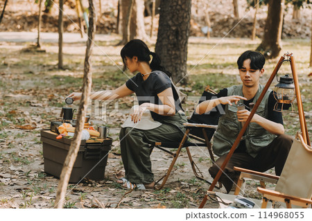 Asian couple sweet in tent inside on they camping trip, traveller relax and sleep togather in out door and camping trip Asian couple sweet in tent inside on they camping trip, traveller relax and sleep togather in out door and camping trip 114968055