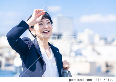 A middle-aged female manager working in the city A middle-aged female manager working in the city 114968149
