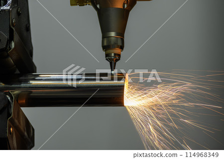 Close up scene the fiber laser cutting machine cut the stainless steel tube and sparkling light. Close up scene the fiber laser cutting machine cut the stainless steel tube and sparkling light. 114968349