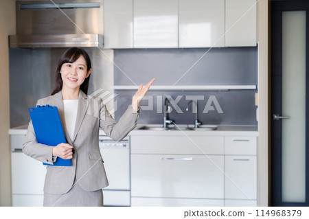 A woman from a real estate agency showing a property 114968379