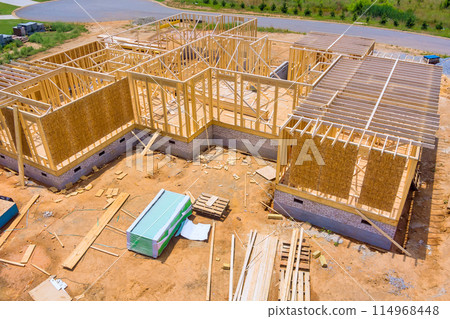 Home residential construction of new house consists of unfinished timber frames wooden beams 114968448