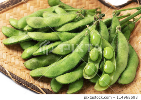 Edamame beans served on a sieve on a white background Edamame beans served on a sieve on a white background 114968698