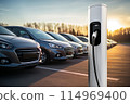 Close-up of a electric charging station on the background of cars 114969400