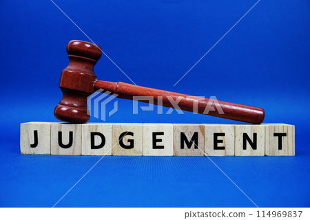 Judgement alphabet letters with wooden blocks alphabet letters and Gavel on blue background Judgement alphabet letters with wooden blocks alphabet letters and Gavel on blue background 114969837