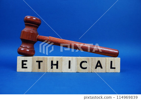 Ethical alphabet letters with wooden blocks alphabet letters and Gavel on blue background Ethical alphabet letters with wooden blocks alphabet letters and Gavel on blue background 114969839