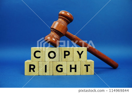 Copy Right alphabet letters with wooden blocks alphabet letters and Gavel on blue background 114969844