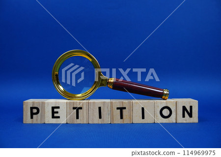 Petition alphabet letters with wooden blocks alphabet letters and Magnifying glass on blue background Petition alphabet letters with wooden blocks alphabet letters and Magnifying glass on blue background 114969975