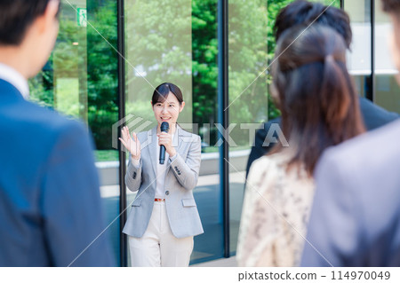 Woman speaking with a microphone 114970049