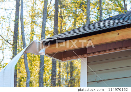 Damaged aluminum fascia trim exposed wood after hurricane storm 114970162